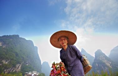Local woman in Yangshou, a town in southern China known for its dramatic mountainscapes